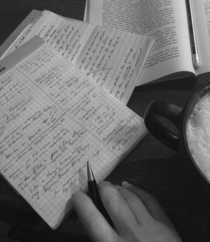 photo of desk with papers, book, coffee